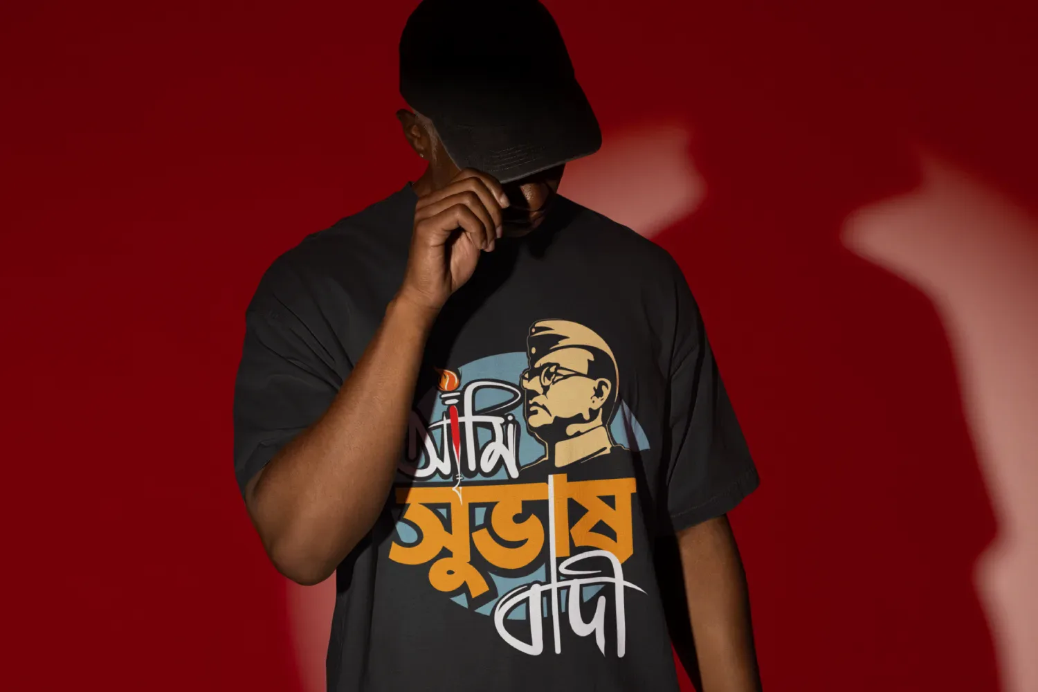 A man wearing a Bengali T-shirt from Bong Street. The print on the t-shirt says Ami Subhashbadi that pays respect to the national hero Netaji Subhash Chandra Bose.
