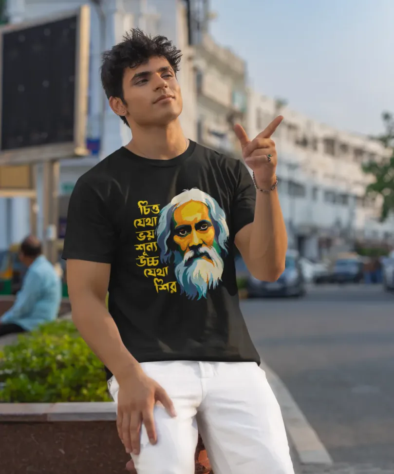 A model wearing a Black unisex t-shirt from BongStreet. The Bengali design shows an animated face of Rabindranath Tagore and the Bengali text says - Chitto jetha bhoyshunyo, Uccho jetha shir.