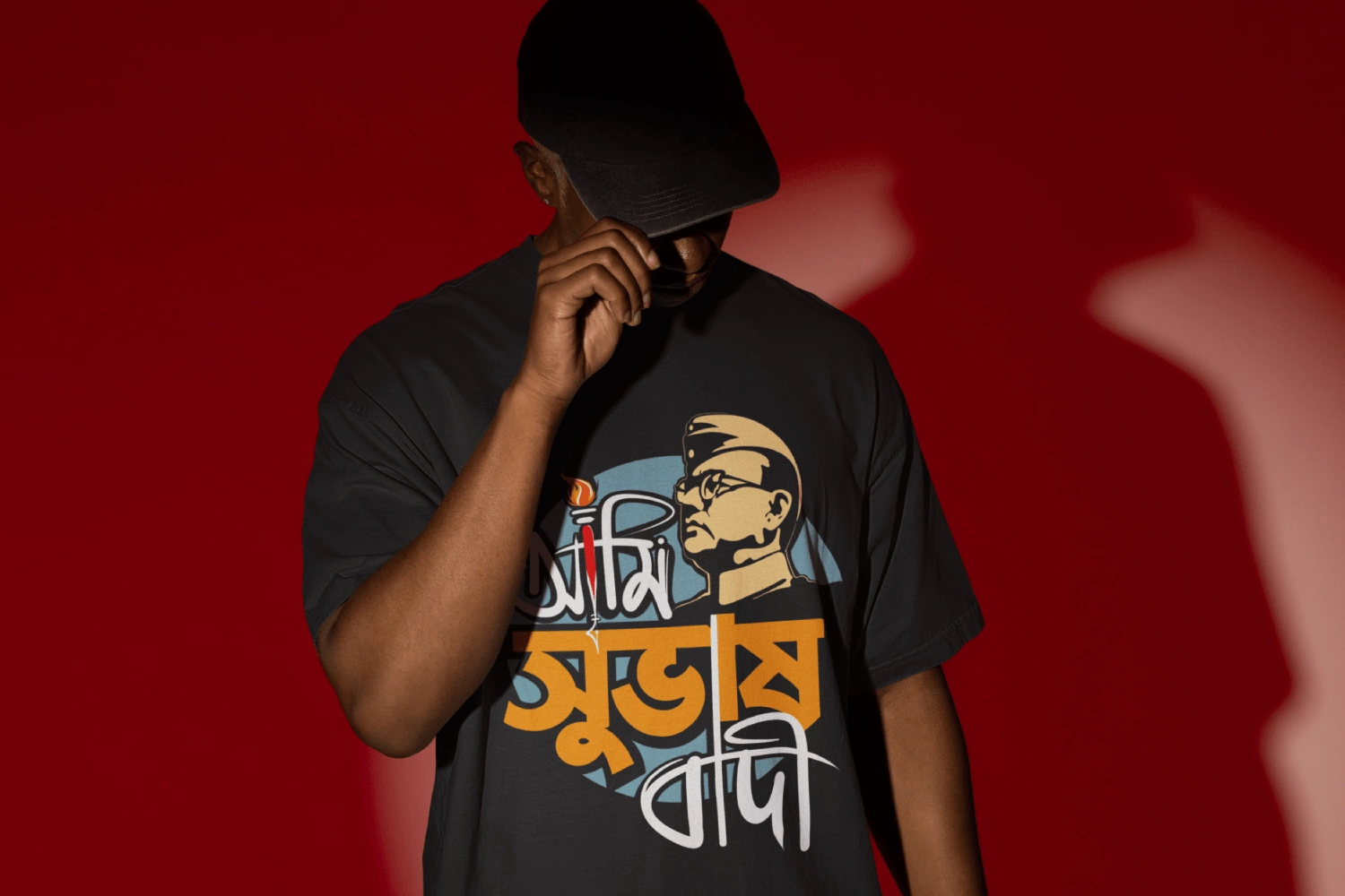 A man wearing a Bengali T-shirt from Bong Street. The print on the t-shirt says Ami Subhashbadi that pays respect to the national hero Netaji Subhash Chandra Bose.